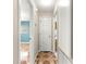 Hallway leads to other rooms; features unique patterned flooring, neutral walls, and doors to bedrooms and bathrooms at 17594 Se 95Th Cir, Summerfield, FL 34491