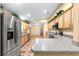 Eat-in kitchen with stainless steel appliances and wood cabinets at 17594 Se 95Th Cir, Summerfield, FL 34491