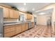 Eat-in kitchen featuring wood cabinets, granite counters and a stainless steel refrigerator at 17594 Se 95Th Cir, Summerfield, FL 34491