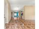 Inviting living room featuring unique tile flooring, neutral walls, and ample space for entertaining guests at 17594 Se 95Th Cir, Summerfield, FL 34491