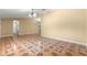 A spacious living room with light-colored walls, a ceiling fan, and intricate tile flooring creating a bright atmosphere at 17594 Se 95Th Cir, Summerfield, FL 34491