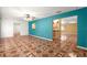 Stylish living room with teal accent wall and unique decorative tile flooring at 17594 Se 95Th Cir, Summerfield, FL 34491