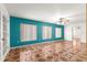 Spacious living room with bright teal walls and decorative tile flooring at 17594 Se 95Th Cir, Summerfield, FL 34491