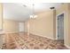 Inviting living area showcasing patterned floors, contemporary lighting, and view of entryway at 17594 Se 95Th Cir, Summerfield, FL 34491