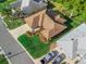 Aerial view of a charming home showcasing a well-manicured lawn and a long driveway leading to the home's entrance at 17898 Se 125Th Cir, Summerfield, FL 34491