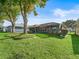 This expansive backyard offers manicured lawn and mature trees providing ample space for outdoor enjoyment and relaxation at 17898 Se 125Th Cir, Summerfield, FL 34491