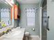 Bathroom with light green walls, marble counter, and glass shower enclosure at 17898 Se 125Th Cir, Summerfield, FL 34491