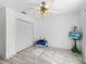 Bedroom with white walls, light wood floors, ceiling fan, and closet with bi-fold doors at 17898 Se 125Th Cir, Summerfield, FL 34491