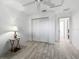 Bedroom featuring white walls, light wood floors, a closet with bi-fold doors at 17898 Se 125Th Cir, Summerfield, FL 34491