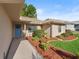 Inviting front entrance with a light blue door, tiled walkway, and mulched garden beds at 17898 Se 125Th Cir, Summerfield, FL 34491