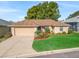 Charming single-story home with a manicured lawn, mature landscaping, and a two-car garage at 17898 Se 125Th Cir, Summerfield, FL 34491