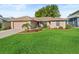 Charming single-story home with a well-maintained lawn and mature landscaping at 17898 Se 125Th Cir, Summerfield, FL 34491