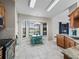 Bright kitchen with stainless steel appliances, granite counters, breakfast nook with large windows, and outdoor access at 17898 Se 125Th Cir, Summerfield, FL 34491