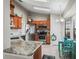 Kitchen featuring stainless steel appliances, beautiful granite countertops, wooden cabinets, and a table with blue accents at 17898 Se 125Th Cir, Summerfield, FL 34491
