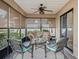 A delightful lanai provides a comfortable seating area with tranquil views and a ceiling fan for relaxed outdoor living at 17898 Se 125Th Cir, Summerfield, FL 34491