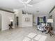 Bright living room featuring tile floors, a ceiling fan, and sliding doors at 17898 Se 125Th Cir, Summerfield, FL 34491