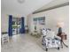 Bright living room with neutral walls, tile floors, and sliding glass door to the patio at 17898 Se 125Th Cir, Summerfield, FL 34491