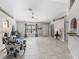 Bright living room featuring tile floors, a ceiling fan, and an open layout at 17898 Se 125Th Cir, Summerfield, FL 34491