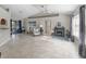 Open-concept living room with neutral walls, tile flooring, and a decorative fireplace at 17898 Se 125Th Cir, Summerfield, FL 34491