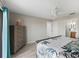 Main bedroom featuring ceiling fan, wood floors, and en suite bathroom with double vanity at 17898 Se 125Th Cir, Summerfield, FL 34491