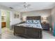 Main bedroom with king bed, ceiling fan, and en suite bathroom with marble counter tops at 17898 Se 125Th Cir, Summerfield, FL 34491