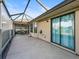 The covered outdoor patio features tile flooring and serene views of the lanai, perfect for Florida evenings at 17898 Se 125Th Cir, Summerfield, FL 34491