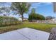 Spacious backyard featuring a chainlink fence and some trees at 17965 Se 107Th Ct, Summerfield, FL 34491