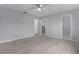 A bedroom with hardwood floors leading to an ensuite bathroom and a walk-in closet at 17965 Se 107Th Ct, Summerfield, FL 34491