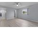 This bedroom features hardwood floors, a ceiling fan, and a window for natural light at 17965 Se 107Th Ct, Summerfield, FL 34491