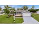 Well-kept home featuring a manicured lawn and a charming covered front porch at 17965 Se 107Th Ct, Summerfield, FL 34491