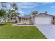 Charming single-story home with well-manicured lawn, gray siding, and a two-car garage at 17965 Se 107Th Ct, Summerfield, FL 34491