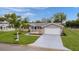 Inviting single-story home featuring a well-kept lawn and a spacious two-car garage at 17965 Se 107Th Ct, Summerfield, FL 34491