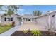 Front exterior of home with a well-maintained lawn and manicured landscaping at 17965 Se 107Th Ct, Summerfield, FL 34491