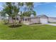 Charming single-story home featuring a well-manicured lawn and attached two car garage at 17965 Se 107Th Ct, Summerfield, FL 34491