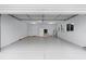 Spacious two-car garage with painted concrete flooring and utility sink at 17965 Se 107Th Ct, Summerfield, FL 34491