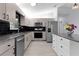 Updated kitchen featuring stainless steel appliances, modern countertops, black subway tile backsplash, and ample storage at 17965 Se 107Th Ct, Summerfield, FL 34491