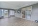Bright and airy sunroom with wood-look tile flooring and a ceiling fan at 17965 Se 107Th Ct, Summerfield, FL 34491