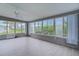 Enclosed sunroom featuring vinyl flooring, windows, and a ceiling fan at 17965 Se 107Th Ct, Summerfield, FL 34491