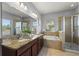 Bathroom with double sink vanity, granite countertop, soaking tub, and glass-enclosed shower, offering a spa-like experience at 1852 Rafton Rd, Apopka, FL 32703