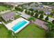 Aerial view of a neighborhood pool, playground, clubhouse, and surrounding green space at 1852 Rafton Rd, Apopka, FL 32703
