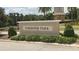 Community entrance featuring a stone monument with the neighborhood name and lush landscaping at 1852 Rafton Rd, Apopka, FL 32703