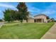 This two-story home boasts a green lawn, mature trees, a two-car garage, and a screened lanai at 1852 Rafton Rd, Apopka, FL 32703