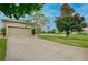 A well-maintained home with a two-car garage, manicured lawn, and mature trees in a suburban neighborhood at 1852 Rafton Rd, Apopka, FL 32703