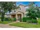 Charming two-story home featuring a manicured lawn and lovely landscaping with a covered front porch at 1852 Rafton Rd, Apopka, FL 32703
