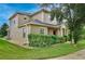 Side view of a two-story home featuring a manicured lawn and landscaping at 1852 Rafton Rd, Apopka, FL 32703