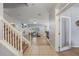 Bright foyer featuring wood-look flooring, staircase with white railing, and living room at 1852 Rafton Rd, Apopka, FL 32703