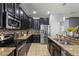 Well-equipped kitchen with stainless steel appliances, mosaic backsplash, and ample cabinet space at 1852 Rafton Rd, Apopka, FL 32703