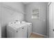 Bright laundry room featuring a Maytag washer and dryer, wire shelving, and a window for natural light at 1852 Rafton Rd, Apopka, FL 32703