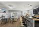 Open-concept living area with modern furnishings, a breakfast bar, and access to outdoor spaces at 1852 Rafton Rd, Apopka, FL 32703