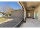 The screened in patio features neutral tones, an outdoor ceiling fan, and beautiful landscaping at 1852 Rafton Rd, Apopka, FL 32703